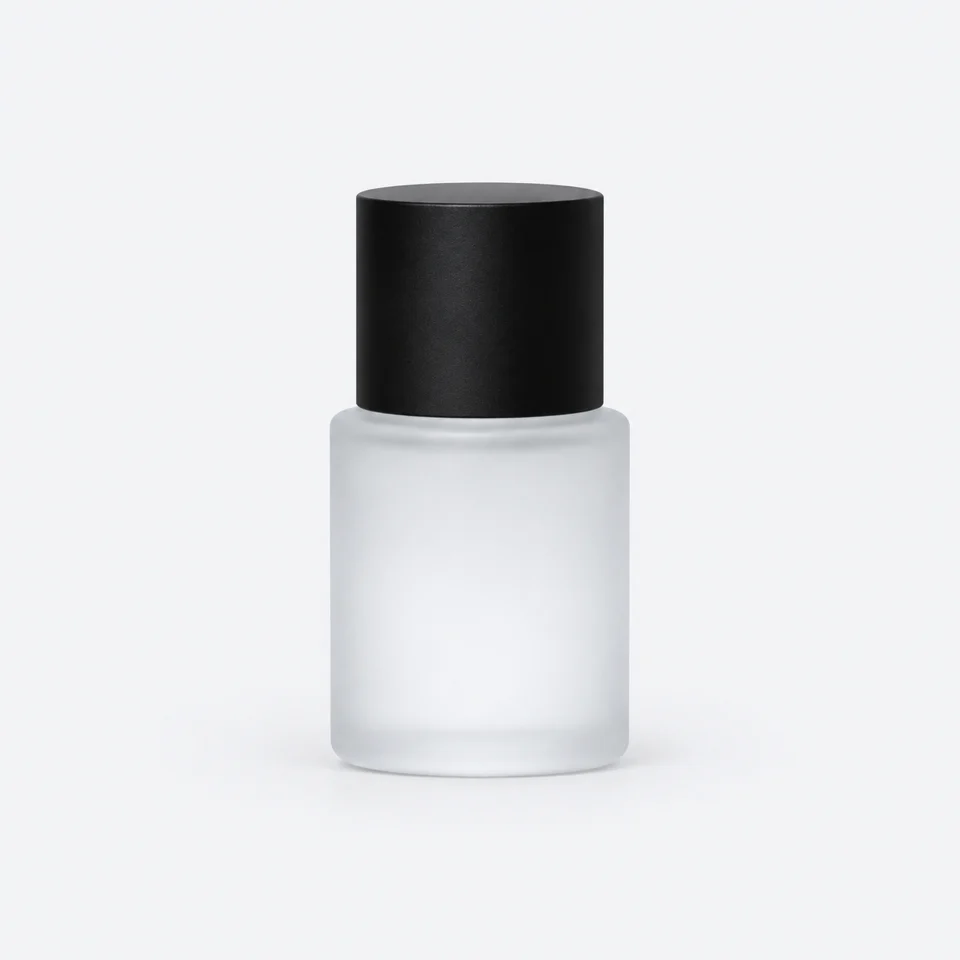 A frosted glass bottle with a black cap on a plain studio background